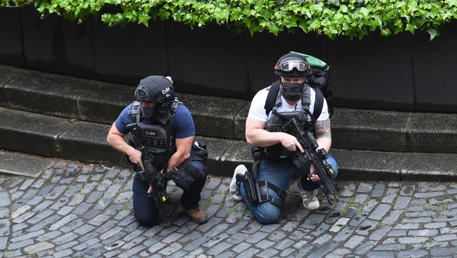 Armed police are seen outside the the Houses of Parliament in London.