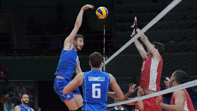 Italy middle blocker Matteo Piano (14) hits the ball against Mexico during the men's preliminary in the Rio 2016 Summer Olympic Games at Maracanazinho.