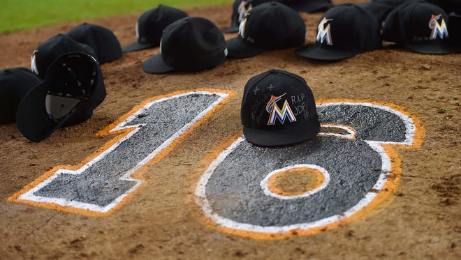 The Marlins' hats are left on the pitchers mound after Miami's win to honor Jose Fernandez at Marlins Park.
