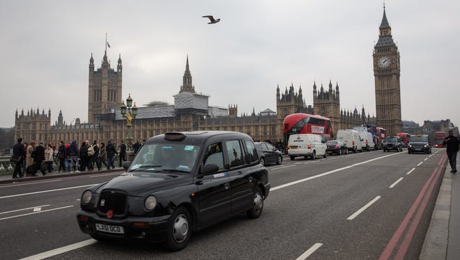 A taxi drives down Westminster Bridge in London, Friday. A fourth person has died after Khalid Masood drove a car into pedestrians on Westminster Bridge before going on to fatally stab PC Keith Palmer on March 22.