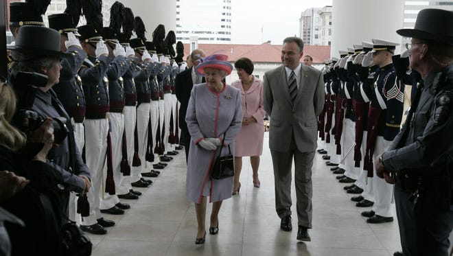 Members of the Virginia Military Institute Corps of Cadets, left, and the Virginia Tech Corps of Cadets, right, salute as Queen Elizabeth II and Kaine enter the Virginia State Capitol in Richmond, Va., on May 3, 2007.