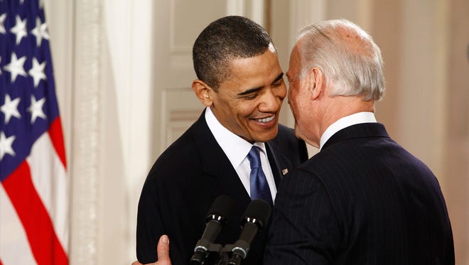 President Barack Obama (L) is embraced by Vice President Joe Biden before signing the Affordable Health Care for America Act during a ceremony in the East Room of the White House on March 23, 2010 in Washington, D.C.