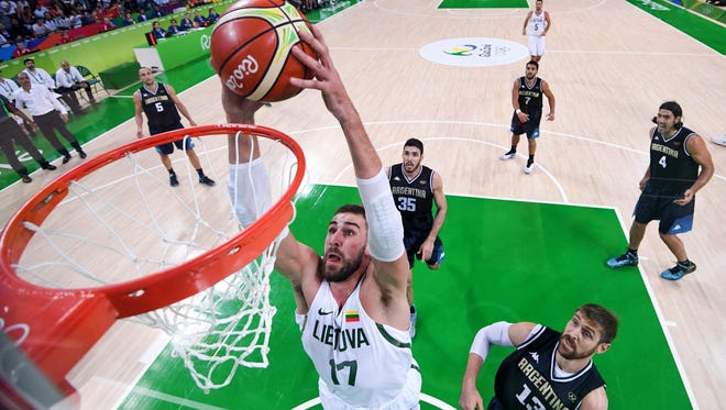 Lithuania center Jonas Valanciunas (17) dunks against Argentina during the men's preliminary round.