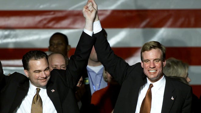 Kaine and Mark Warner celebrate at a rally in Richmond, Va., on Nov 6, 2001, after Warner was elected governor and Kaine was elected lieutenant governor.