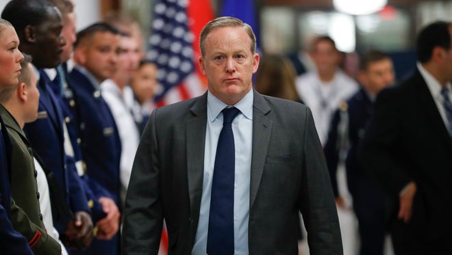 Spicer walks down the hallway during President Trump's visit to the Pentagon on July 20, 2017.