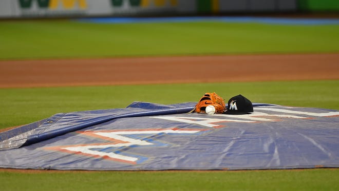 A ball, hat and glove is left on the pitchers mound at Marlins Park.