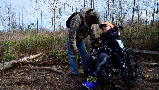 Bill Kohler bends down to talk to his son, Ayden Zeigler-Kohler, 10, in the Sproul State Forrest in Noyse Township on March 9. Ayden and his father, Bill Kohler, left, were invited to hold bear cubs who were being checked on as a part of a study by the Pennsylvania Game Commission, after a Wildlife Conservation Officer read their story. In a wish journal Ayden wrote that if he was sick and dying, he wanted to be in the woods. Ayden, who had a rare childhood cancer, died Wednesday at his home in Springettsbury Township.