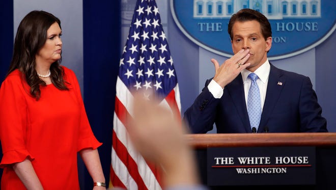 Sarah Huckabee Sanders, left, the new White House press secretary, watches as Scaramucci blows a kiss after answering questions during the press briefing on July 21, 2017.