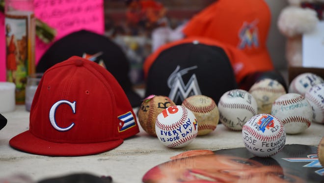 A memorial of signed shirts and hats are placed outside a gate at Marlins Park in honor of Jose Fernandez.