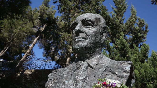 A bronze chest statue of late Israeli ex-president and Nobel Peace Prize winner Shimon Peres is taken at the gardens of the President's Residence in Jerusalem.
