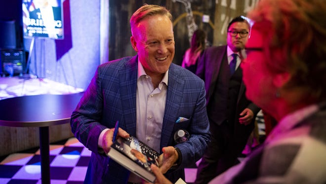Former White House Press Secretary Sean Spicer signs a copy of his new book "The Briefing: Politics, The Press, and The President," at a launch party on July 24, 2018 in Washington, DC.