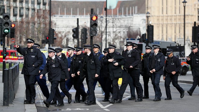 Police officers gather near the Houses of Parliament in London.