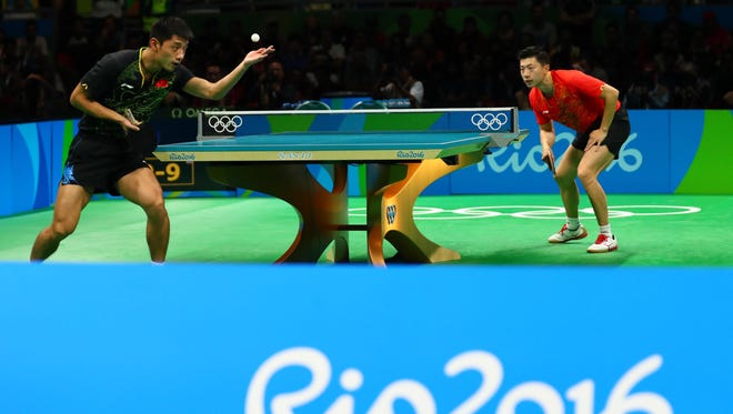 Long Ma (CHN) in action against Jike Zhang (CHN) during the men's singles table tennis gold medal match.