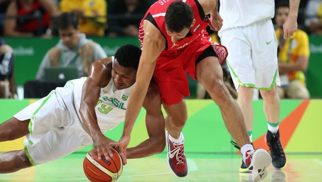 Roko Ukic of Croatia, right, and Leandro Barbosa of Brazil chase a ball during the men's preliminary round in the Rio 2016 Summer Olympic Games at Carioca Arena 1.