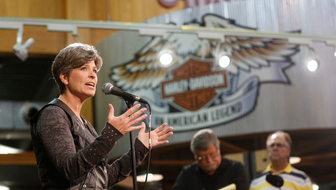Sen. Joni Ernst takes questions from members of the media Saturday, Aug. 27, 2016, before heading out from the Big Barn Harley Davidson dealership to the Iowa State Fairgrounds for the second annual Roast and Ride in Des Moines.