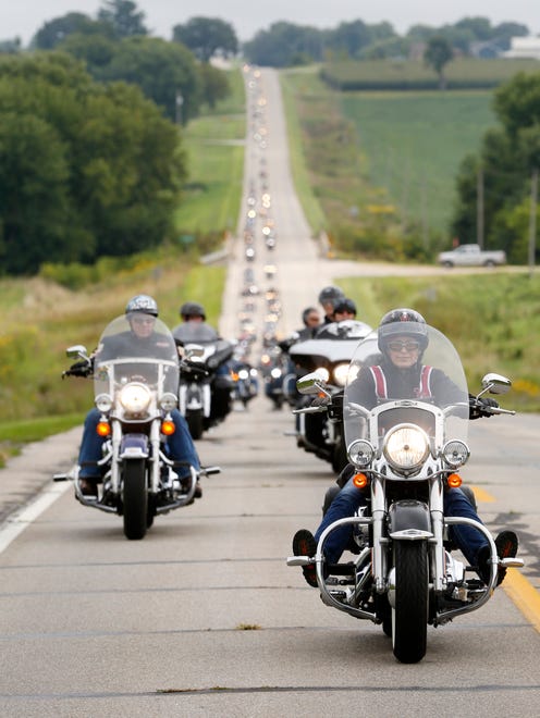 Sen. Joni Ernst (right) leads bikers along the route Saturday, Aug. 27, 2016, as they make their way to the Iowa State Fairgrounds for the second annual Roast and Ride fundraiser in Des Moines.