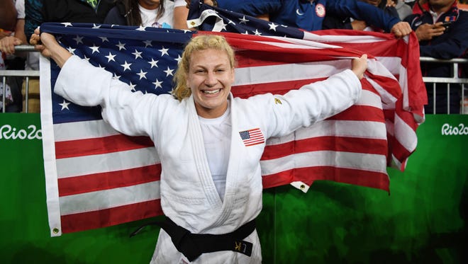 Kayla Harrison (USA, white) reacts with fans after defeating Audrey Tcheumeo (FRA) in the women's 78kg gold medal judo contest at Carioca Arena 2 during the Rio 2016 Summer Olympic Games.