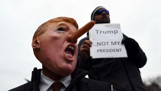 Demonstrators protest against US President-elect Donald Trump before his inauguration in Washington, DC.