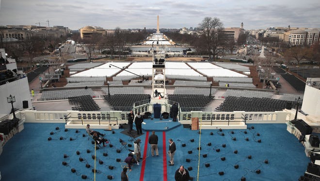 Workers prepare the stage for the inauguration ceremony of President-elect Donald Trump on Jan. 19, 2017, in Washington.