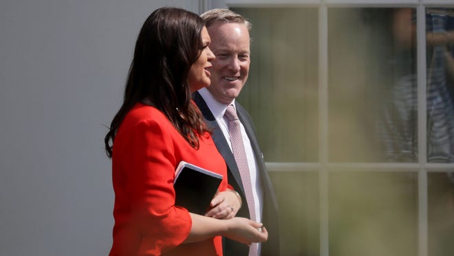 Spicer and new press secretary Sarah Huckabee Sanders walk out of the White House on July 21, 2017, the day Spicer announced his resignation.