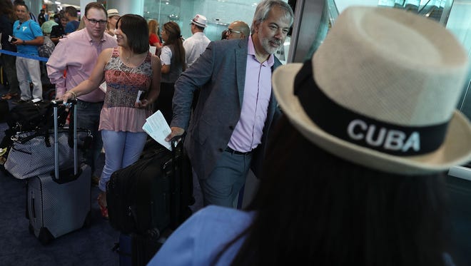 Passengers line up to board American Airlines Flight 903 to Cuba, becoming the first commercial flight from Miami to Cuba in 55-years on Sept. 7, 2016.