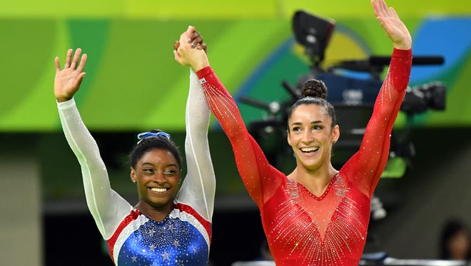 Simone Biles (USA) and Alexandra Raisman (USA) celebrate after the gold and silver medal during the women's individual all-around final in the Rio 2016 Summer Olympic Games at Rio Olympic Arena.
