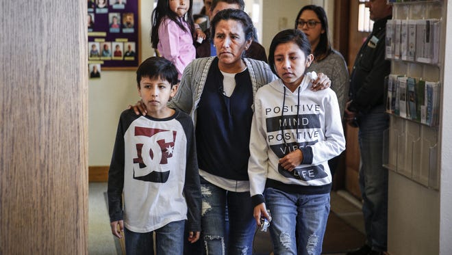 Undocumented immigrant and activist Jeanette Vizguerra, 45, walks into press conference with two of her children Roberto, 10, and Luna Baez, 12, before addressing supporters and the media while seeking sanctuary at First Unitarian Church in Denver on Feb. 15, 2017.