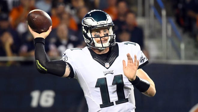 Philadelphia Eagles quarterback Carson Wentz (11) drops back to pass against the Chicago Bears during the second quarter at Soldier Field.
