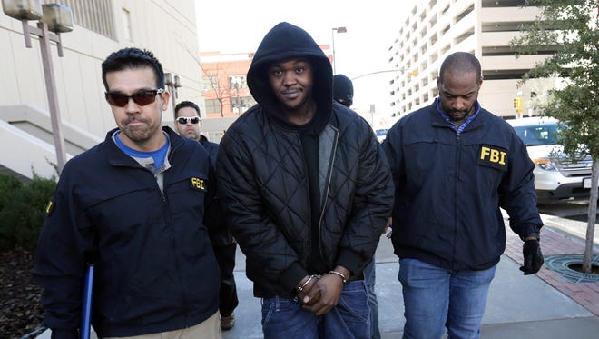 FBI Most Wanted suspect Terry A.D. Strickland was captured Jan. 15 in El Paso. Above, Strickland walks into the El Paso County Jail escorted by the FBI agents who captured him.