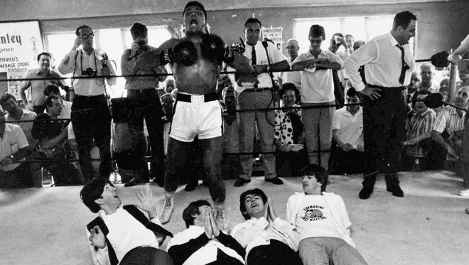 Cassius Clay (aka Muhammed Ali) posed jokingly with The Beatles on Feb. 18, 1964. The bandmates visited the boxing contender at his training camp in Miami a week after their 'Ed Sullivan' appearance.