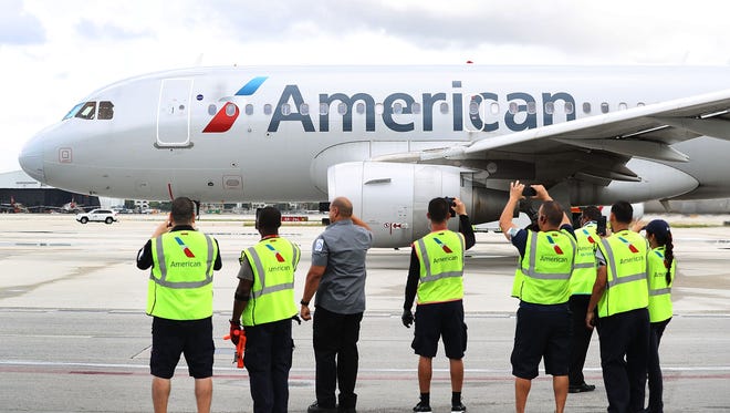 Employees watch as American Airlines Flight 903 prepares to become the first commercial flight from Miami to Cuba in 55-years on Sept. 7, 2016.