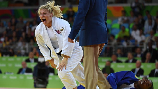 Kayla Harrison (USA, white) reacts after defeating Audrey Tcheumeo (BRA, blue) in the women's 78kg gold medal judo contest at Carioca Arena 2 during the Rio 2016 Summer Olympic Games.