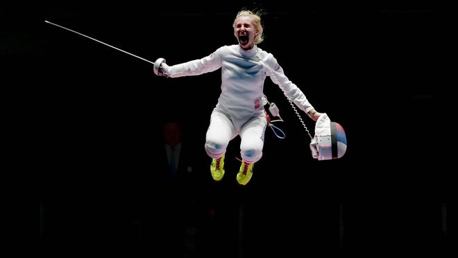 Violetta Kolobova (RUS), jumps in the air as she celebrates winning the bout against Irina Embrich (EST) and claiming the bronze medal in the women's epee team match at Carioca Arena 3 in the Rio 2016 Summer Olympic Games.