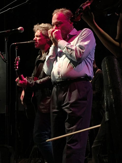 Tim Kaine plays harmonica alongside Jon Bon Jovi at a get-out-the-vote rally at the State Theater in St. Petersburg, Fla., on Nov. 5, 2016.