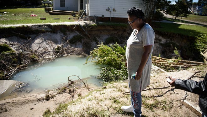 Evelyn McCormick looks out at what used to be her backyard on Oct. 11, 2016, in Hope Mills, N.C.,  after it was wiped away by Hurricane Matthew.