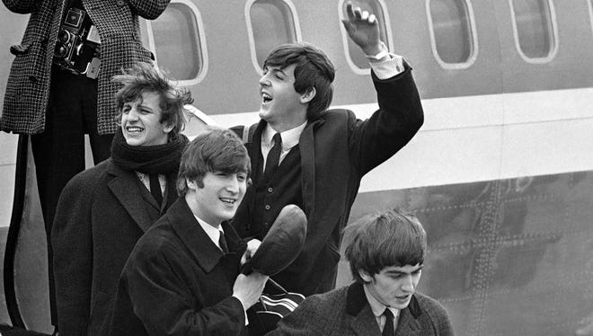 The Beatles land on Feb. 7, 1964, at John F. Kennedy airport in New York for their historic appearance on 'The Ed Sullivan Show.' Nielsen says 45% of all TV sets in use at the time were tuned into the broadcast,