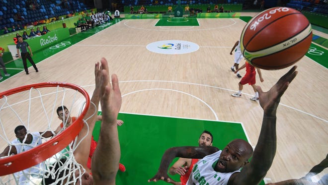 Nigeria forward Al-Farouq Aminu (7) goes up for a shot over Spain defense during the men's preliminary round in the Rio 2016 Summer Olympic Games at Carioca Arena 1.