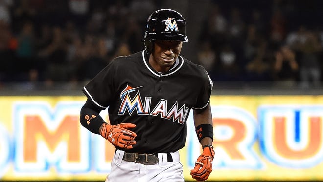 An emotional Dee Gordon rounds the bases after hitting a solo home run.