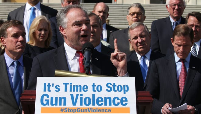 Kaine is flanked by Senate colleagues while speaking about gun control during a news conference on the Senate steps at the Capitol on Oct. 8, 2015.