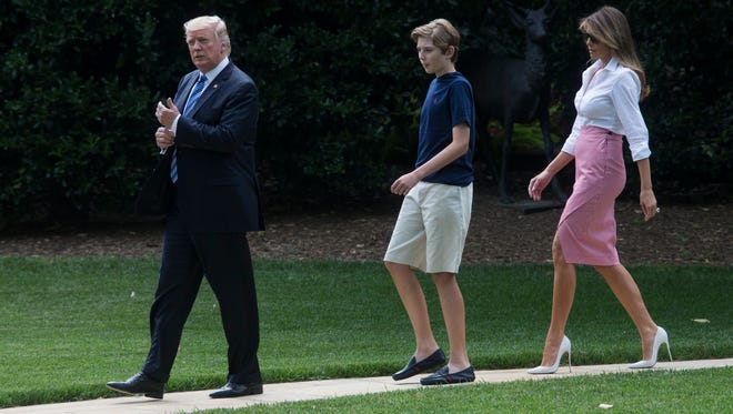 President Donald J. Trump, First Lady Melania Trump and their son Barron Trump  walk outside the Oval Office to depart the South Lawn of the White House by Marine One, in Washington, DC on June 30, 2017. Trump travels to Bedminster, New Jersey.