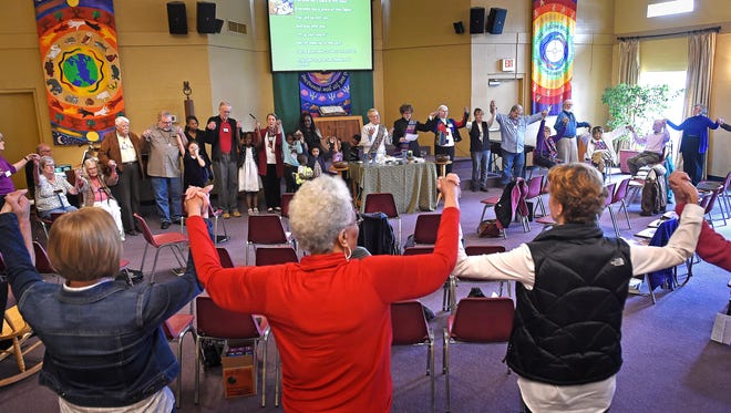 The congregation holds hands and prepares for communion at Edgehill United Methodist Church in Nashville. The church has always been inclusive. Now it says becoming a sanctuary church is a big priority for its congregation, which has a long history of social justice work, on Feb. 19, 2017.