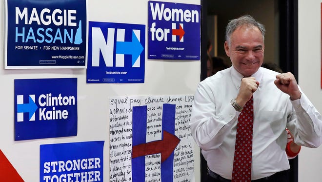 Kaine pumps his fists after being introduced during a campaign stop on Sept. 1, 2016, in Dover, N.H.