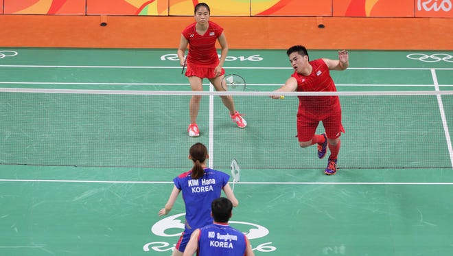 Jamie Subandhi and Phillip Chew of the United States (in red) compete against Korea during the mixed doubles in the Rio 2016 Summer Olympic Games at Riocentro - Pavilion 4.