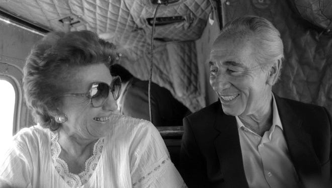 A handout picture dated May 7, 1985, provided by the Israeli Government Press Office in 2011 shows veteran Israeli statesman Shimon Peres (R) with his wife Sonya (L) as they fly together in a helicopter over northern Israel to Kibbutz Alumot, a community that they both helped to found. According to Israeli media, Peres died on Tuesday in Israel at the age of 93.