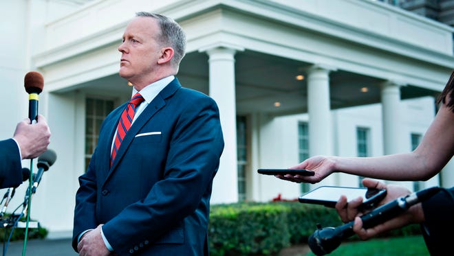 Spicer speaks to a reporter about a comparison he made between Syrian President Bashar al-Assad and Hitler during an earlier press briefing at the White House on April 11, 2017.