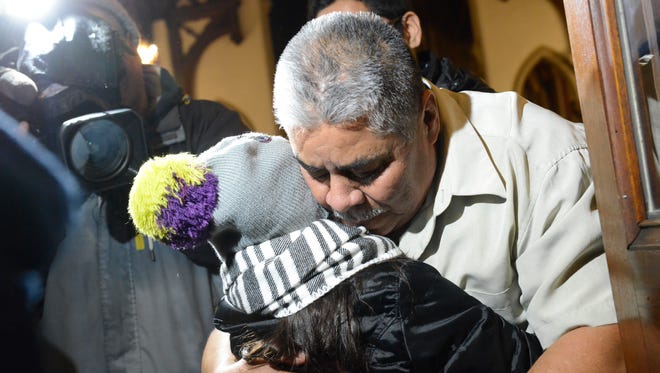 Catalino Guerrero of Union City hugs his granddaughter, Elizabeth Perez, 7, at Grace Episcopal Church on March 10, 2017. Guerrero, facing deportation, was given a stay until May when he will have to report to the U.S. Immigration and Customs Enforcement again.
