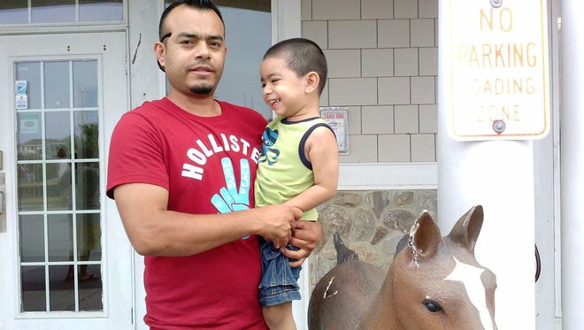 Angel Ortiz Paz holds Angel Jr., his 6-year-old-son. Ortiz has lived in the U.S. for 17 years, but was recently arrested by Immigration and Customs Enforcement agents and may be deported back to his native Honduras.