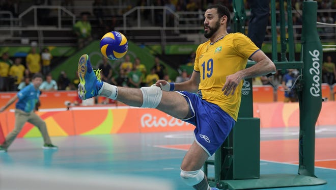 Brazil wing spiker Mauricio Borges Almeida Silva attempts to save the ball from going out of bounds against the United States during the men's preliminary.