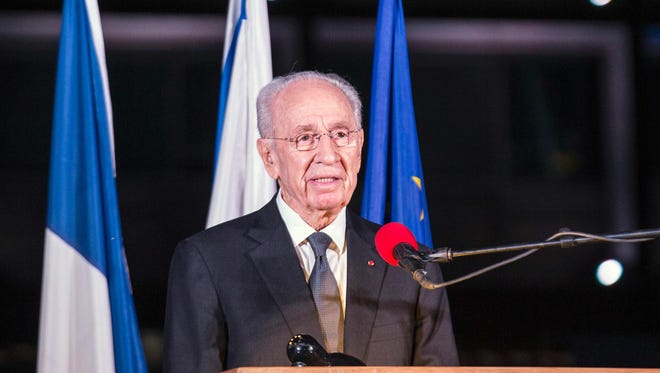Former Israeli President Shimon Peres delivers a speech in honor of the victims of the Paris attacks in Rabin Square in the Israeli coastal city of Tel Aviv.