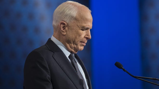 Incumbent Sen. John McCain reads over notes before a debate for the U.S. Senate against Rep. Ann Kirkpatrick on Arizona PBS on October 10, 2016 in Phoenix, Ariz.